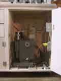 The pump is housed under the manifold behind the door