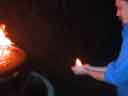 Bob holds flames -- side